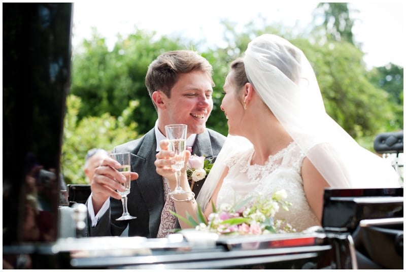 Happy married couple with champagne at Ringwood Church