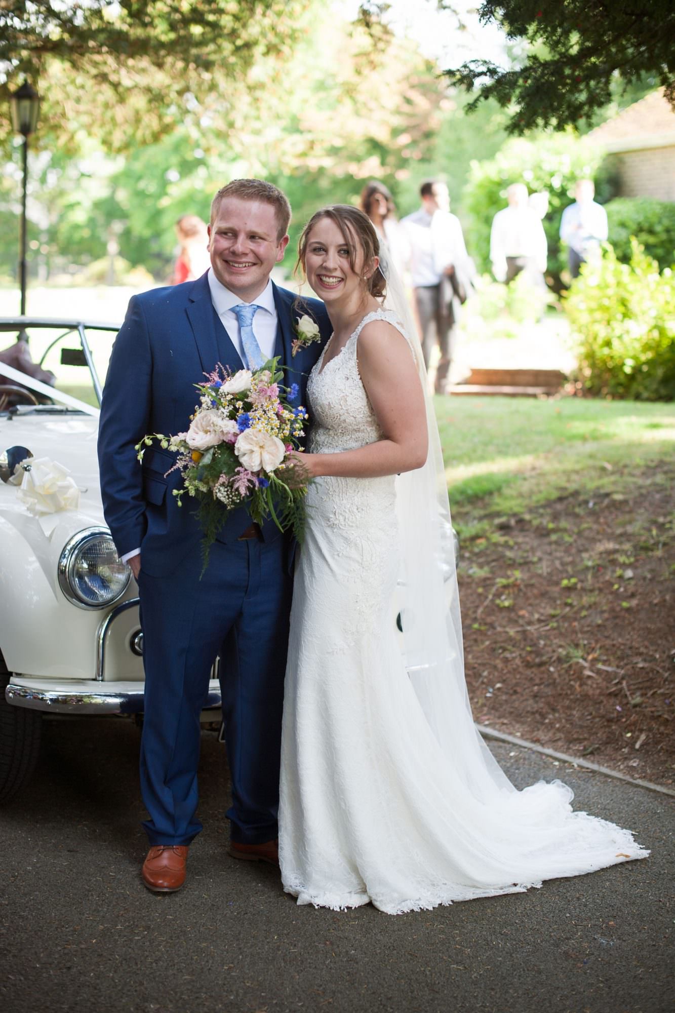 Bride and groom with Morris Minor in Dorset