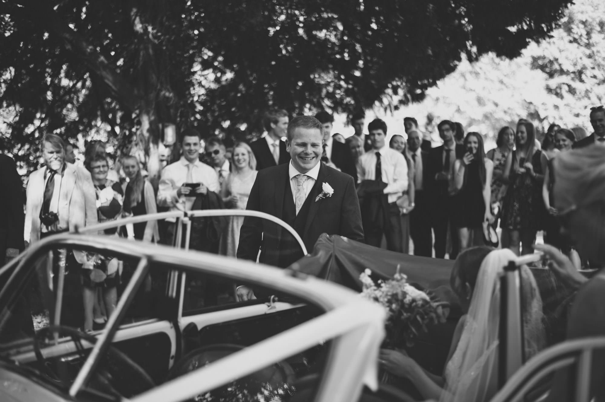 Dorset groom with Morris Minor at Canford church