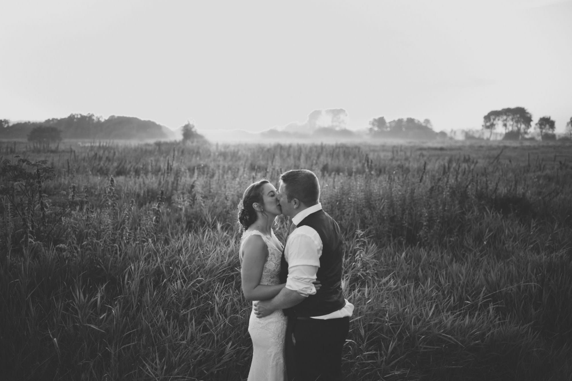 Wedding couple during golden hour mist at Sopley Mill