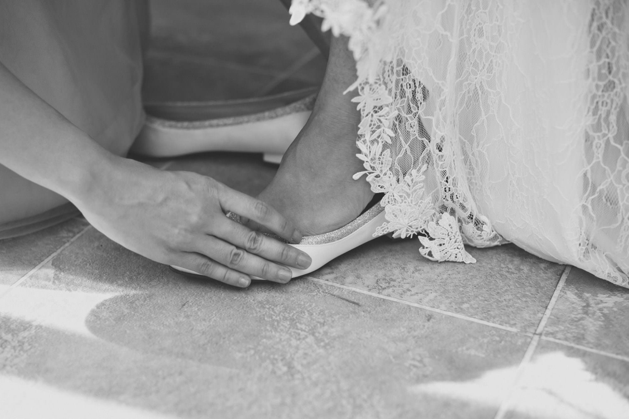 Dorset bride putting on Rainbow Bridal shoes