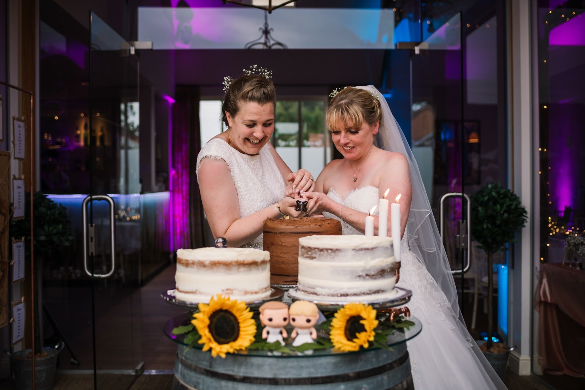 Cutting the cake at Three Choirs Vineyard wedding
